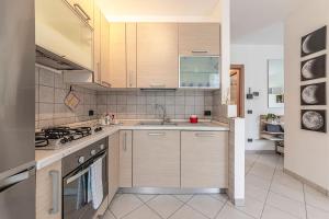 a kitchen with a sink and a stove at LAGO DI COMO - In Centro a 1 min da Lago e Stazione - Wifi in Lecco