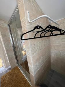 a shower with a hanger in a bathroom at Quay Central in Exeter