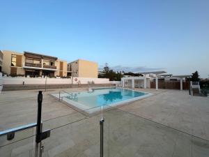 a swimming pool in the middle of a building at Surf Station Tenerife Holiday Apartment Las Americas in Playa de las Americas