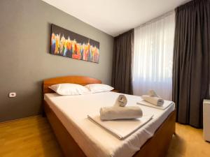 a bedroom with a bed with towels on it at GRAND - Beachfront Rooms & Apartments in Selce +16 photos