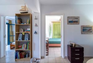 a room with a room with a book shelf and a bedroom at Villa Amerita in Elia Laconias