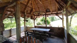 an inside view of a wooden cabin with a table and chairs at Apartman Mitrić in Šipovo