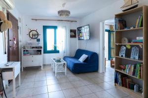 a living room with a blue couch and a table at Villa Amerita in Elia Laconias +24 photos