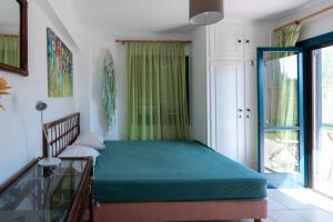 a bedroom with a bed and a glass table at Villa Amerita in Elia Laconias