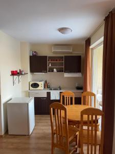 a kitchen with a table and chairs in a kitchen at Viva Apartment in Sunny Beach