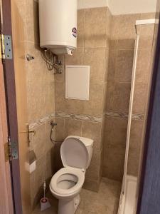 a small bathroom with a toilet and a water tank at Viva Apartment in Sunny Beach