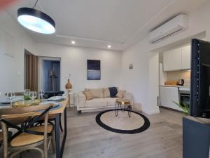 a living room with a table and a couch at Seaside Murter Apartments in Murter
