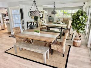 a dining room and living room with a table and chairs at Family friendly with large pool in Sarasota