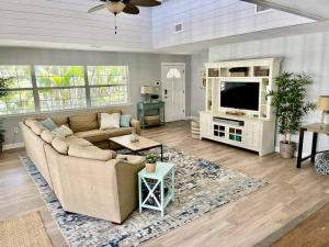 a living room with a couch and a tv at Family friendly with large pool in Sarasota