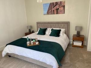 a bedroom with a bed with a tray of food on it at Glen Lyon Lodge Bed and Breakfast in Nairn