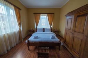 a bedroom with a bed and a large window at Prenoćište Dajević Hotel Tara Pljevlja in Pljevlja