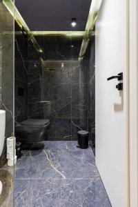 a bathroom with a toilet and a glass door at Style and luxury 10mins Center in Plovdiv