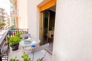 a balcony with a table and chairs on a balcony at Akheilos in Soverato Marina