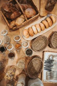 a table topped with lots of different types of bread at HENRI Country House Kitzbühel in Kitzbühel