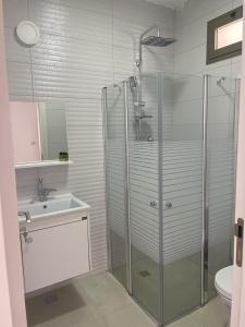 a bathroom with a shower and a sink at במורד ההר in Shelomi