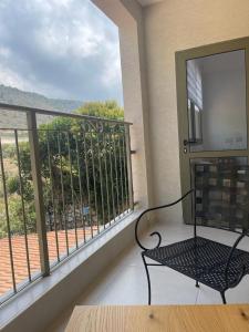 a balcony with a bench sitting on a balcony at במורד ההר in Shelomi +4 photos