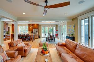 a living room with leather furniture and a ceiling fan at Stockbridge Retreat with Pool and Hot Tub! in Stockbridge