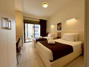 a hotel room with two beds and a balcony at Hayali Suites in Jounieh