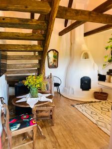 a living room with a table and a fireplace at Inside, The Village- Wooden Hideaway 