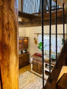 a kitchen with wooden cabinets and a table in a room at Inside, The Village- Wooden Hideaway in Tunari