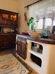 a kitchen with a counter top with a sink at Inside, The Village- Wooden Hideaway 