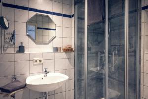 a bathroom with a sink and a shower at Landgasthof Waldrast in Vöhrenbach