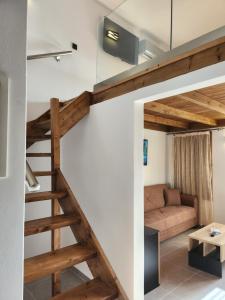 a living room with a staircase and a couch at Kastello in Meyisti