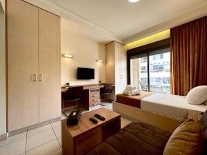 a hotel room with a bed and a tv at Hayali Suites in Jounieh