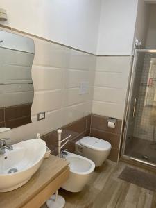 a bathroom with a sink and a toilet and a shower at Casa di nonno sta in Santa Maria di Castellabate