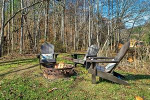 two chairs and a fire pit in a yard at Spectacular MTNS Views with PRIVATE HOT TUB with Pool Table and Private Pond in Sevierville