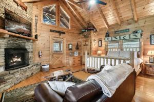 a living room with a fireplace in a log cabin at Spectacular MTNS Views with PRIVATE HOT TUB with Pool Table and Private Pond in Sevierville