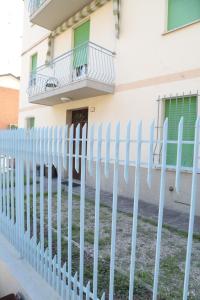 uma cerca branca em frente a um edifício em Guest House Malaguzzi em Reggio Emilia