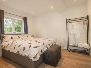 a bedroom with a large bed with red birds on it at Pheasant View in Truro