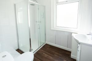 a bathroom with a shower and a toilet and a sink at The Sea Lynn in Morecambe