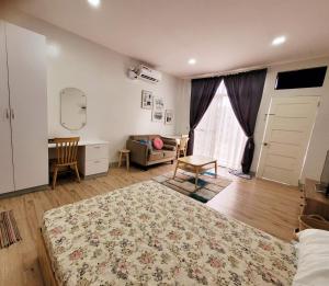 a bedroom with a bed and a desk and a window at CAP Apartments in Talibon