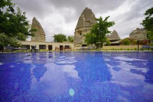 a large swimming pool in front of a building at A la mode Cappadocia in Göreme
