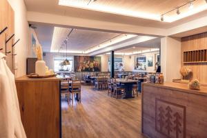a restaurant with wooden floors and tables and chairs at Landgasthof Waldrast in Vöhrenbach
