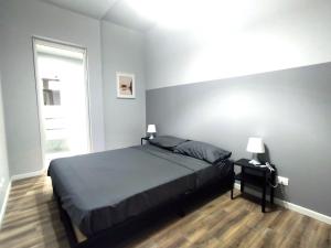 a bedroom with a large bed and a window at Casa Wally in Turin