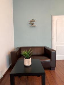 a living room with a brown couch and a table at Color Apartments Nicolae Tonitza St in Bucharest