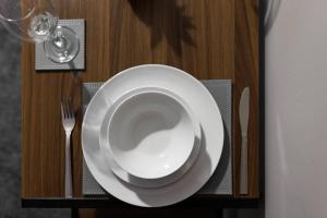 a plate on a table with a fork and a glass at City Centre Studio 8 with Kitchenette, Free Wifi and Smart TV with Netflix by Yoko Property in Middlesbrough