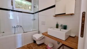 a white bathroom with a sink and a toilet at Sea Breeze - Barcola - Trieste Reception in Trieste