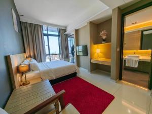 a hotel room with a bed and a red rug at The Honeymoon Haven - 99 Residences in Melaka