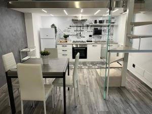 a kitchen with a dining table and white appliances at Life Rooms in Misilmeri