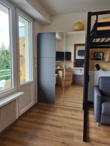 a living room with a sliding glass door to a bedroom at Studio cosy et lumineux bike parking in Saverne