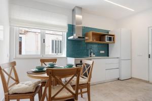 a kitchen and dining room with a table and chairs at Old Town Apartments City in Lagos