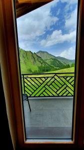 a window with a view of a mountain view at Engadin Lodge PREMIUM & PRIVATE in Samnaun
