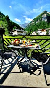 a table with food on it on a patio at Engadin Lodge PREMIUM & PRIVATE in Samnaun