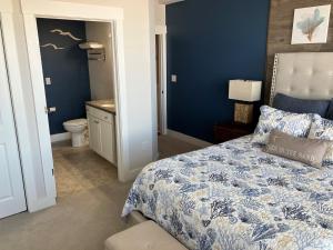 a blue bedroom with a bed and a bathroom at SC302 - C-View in Kill Devil Hills +34 photos