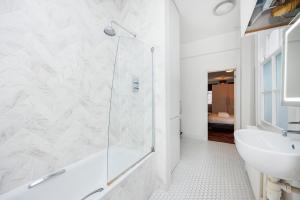 a bathroom with a shower and a sink at Dynamic in Dean Street in London