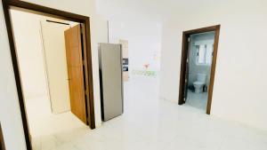 a hallway with two open doors in a room at Peaman Court in Marsaskala